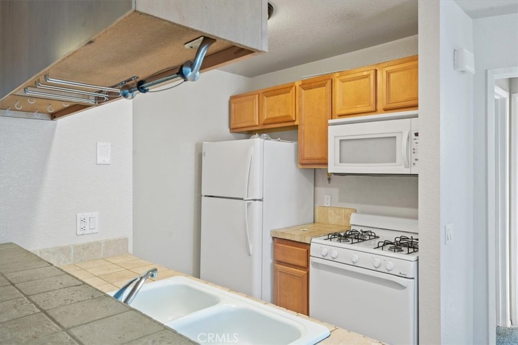 760 Blue Jay Road, Unit 48 Big Bear Lake, CA 92315 - Photo 17 of 31 a kitchen with a refrigerator and a stove