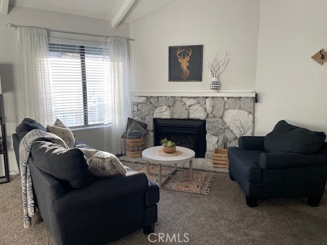 760 Blue Jay Road, Unit 48 Big Bear Lake, CA 92315 - Photo 4 of 31 a living room with furniture and a fireplace