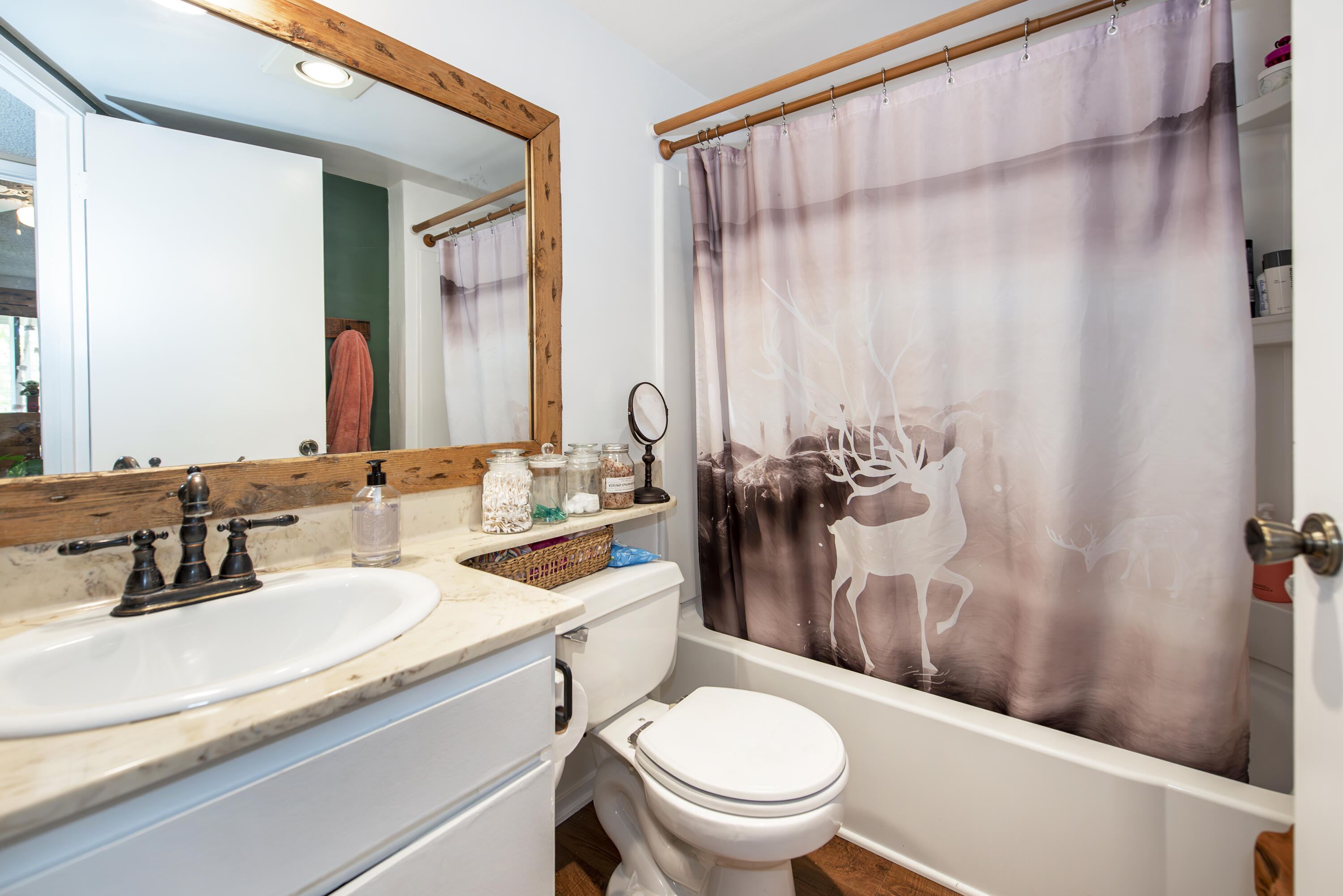 214 North R Street Lompoc, CA 93436 - Photo 11 of 15 a bathroom with a sink a toilet and a mirror