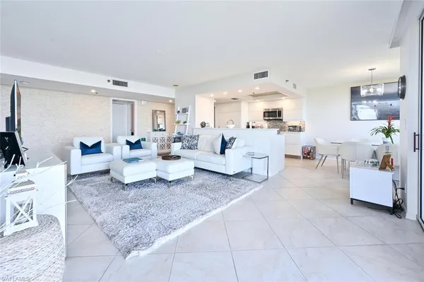a living room with furniture and white walls