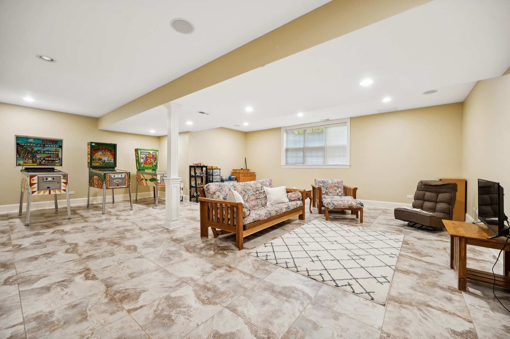 1622 Brandon Road Glenview, IL 60025 - Photo 23 of 31 a spacious bedroom with a bed a table and a flat screen tv
