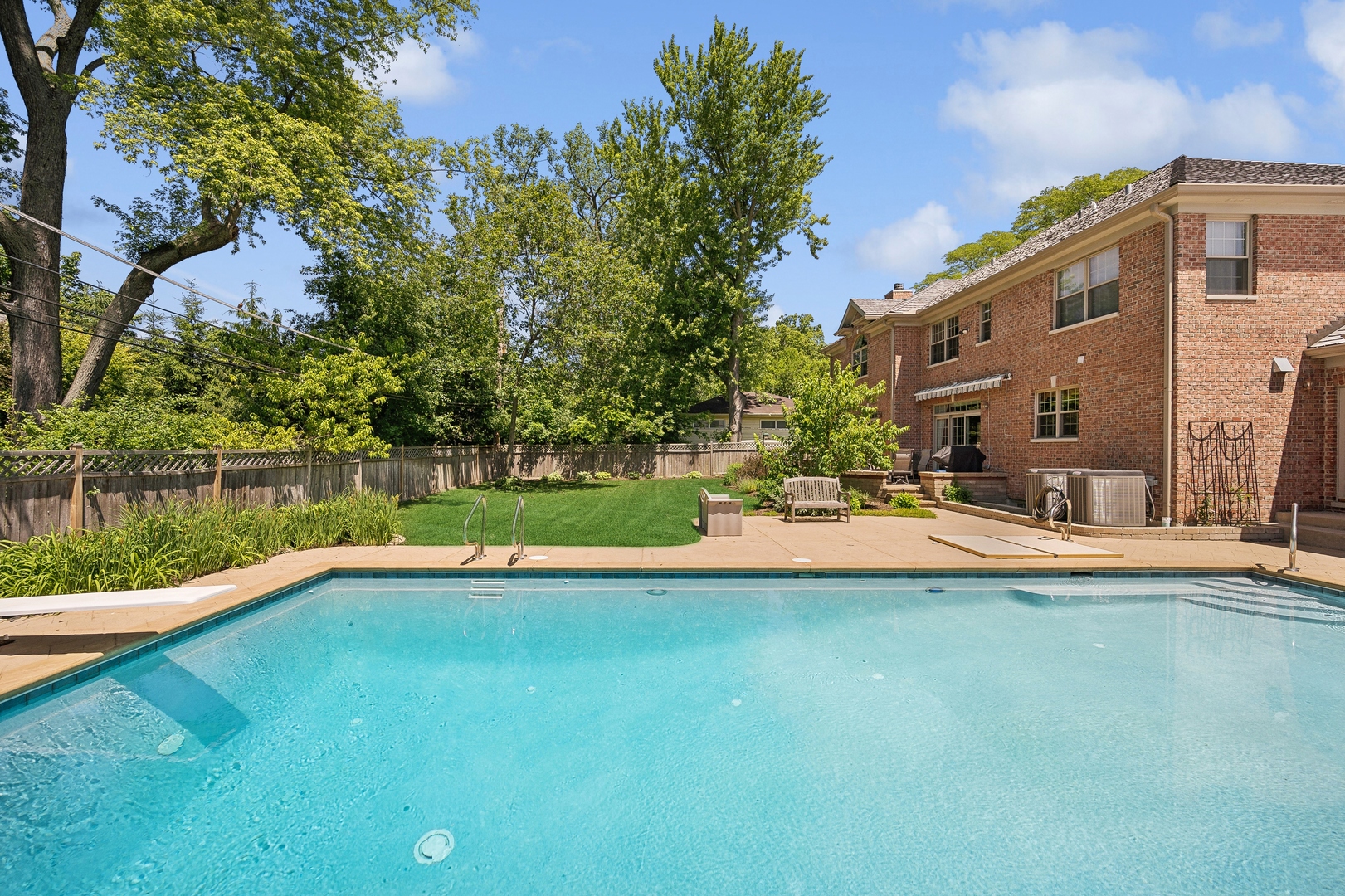 1622 Brandon Road Glenview, IL 60025 - Photo 26 of 31 a view of a house with a swimming pool and a yard