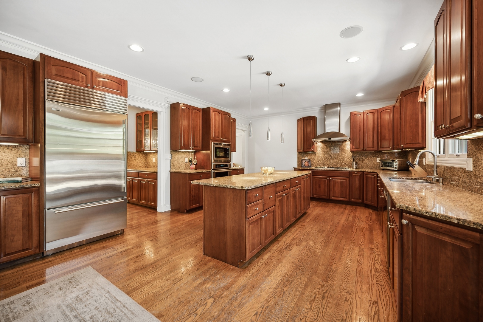 1622 Brandon Road Glenview, IL 60025 - Photo 6 of 31 a large kitchen with stainless steel appliances kitchen island granite countertop a refrigerator and a stove top oven