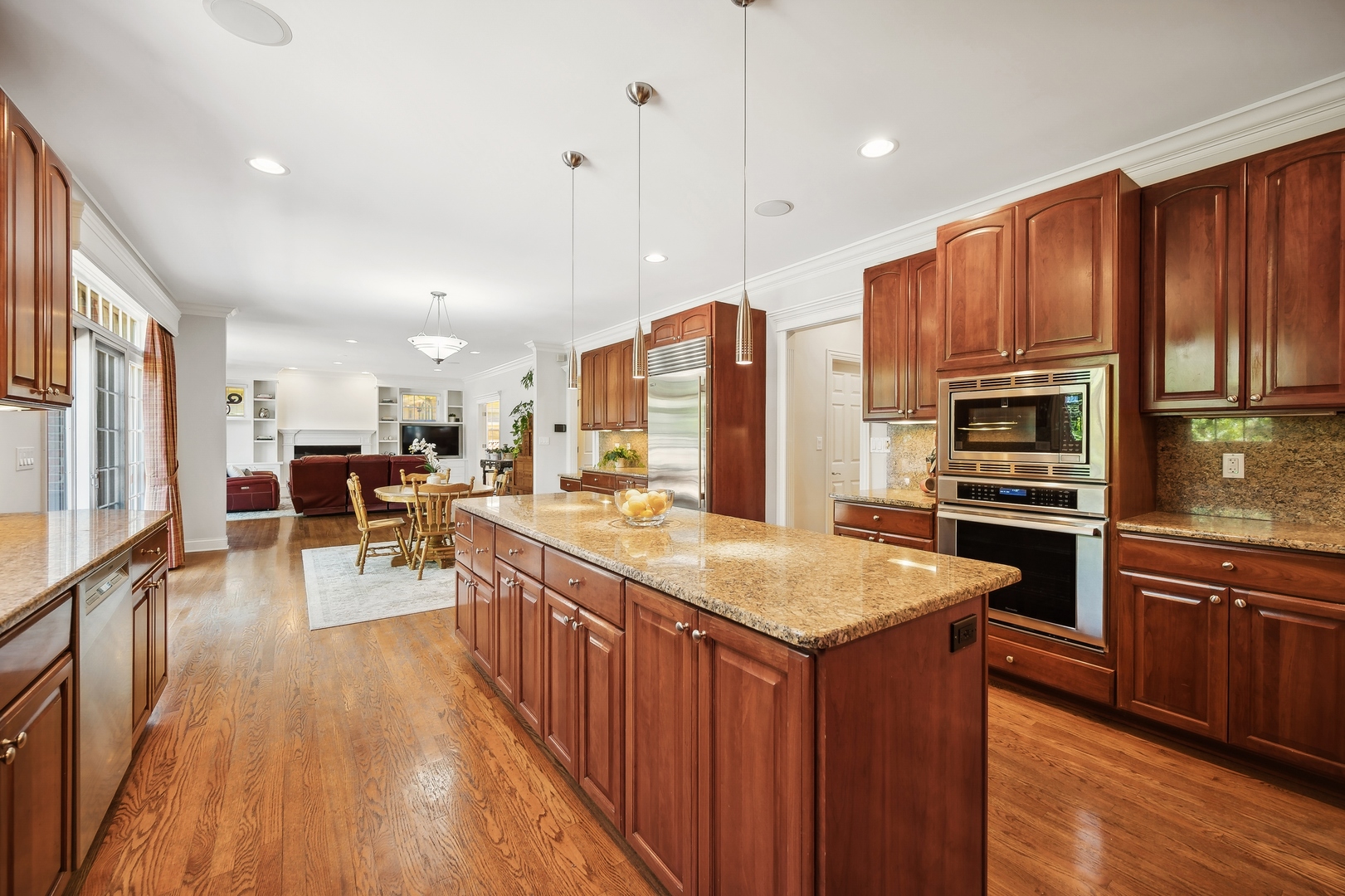 1622 Brandon Road Glenview, IL 60025 - Photo 7 of 31 a kitchen with stainless steel appliances a stove top oven a refrigerator a sink and dishwasher with wooden floor