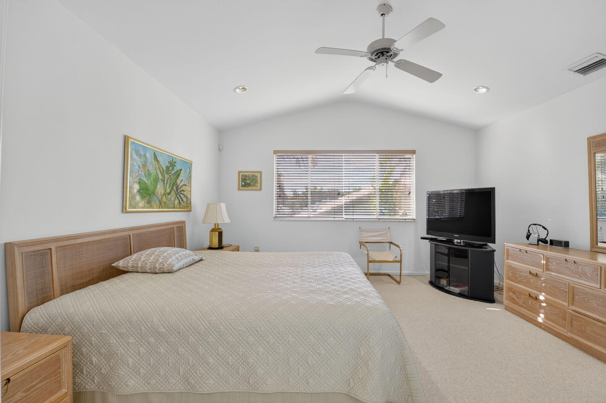 5309 Northwest 26th Circle Boca Raton, FL 33496 - Photo 18 of 37 a bedroom with a large bed and a flat tv screen on dresser