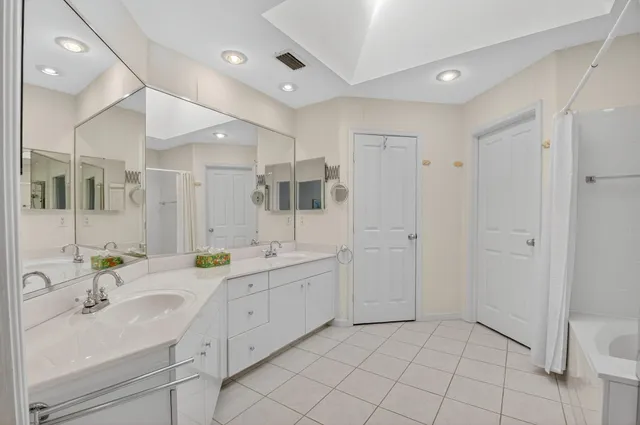 a spacious bathroom with a double vanity sink mirror and