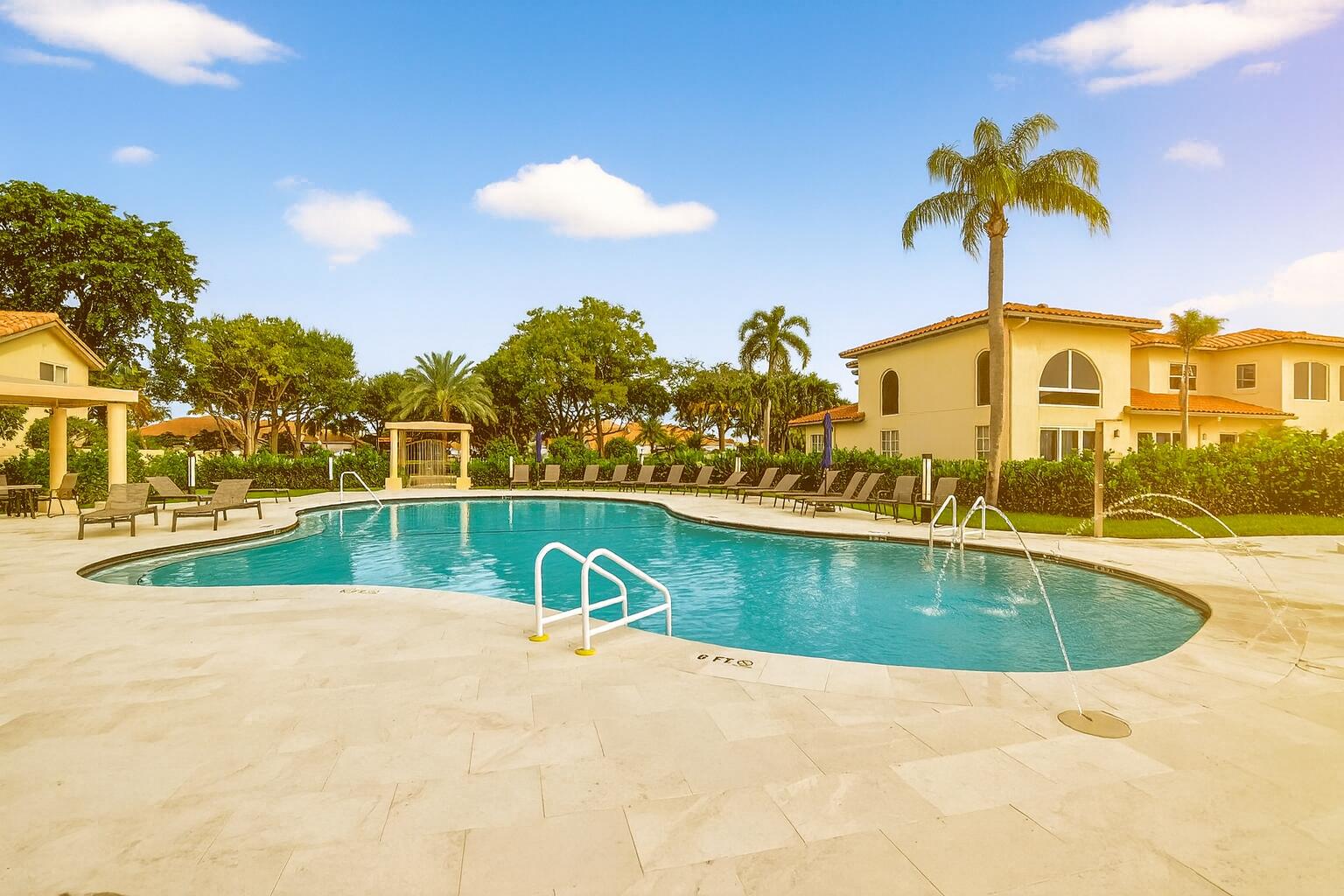 5309 Northwest 26th Circle Boca Raton, FL 33496 - Photo 26 of 37 a view of a swimming pool with a lounge chair