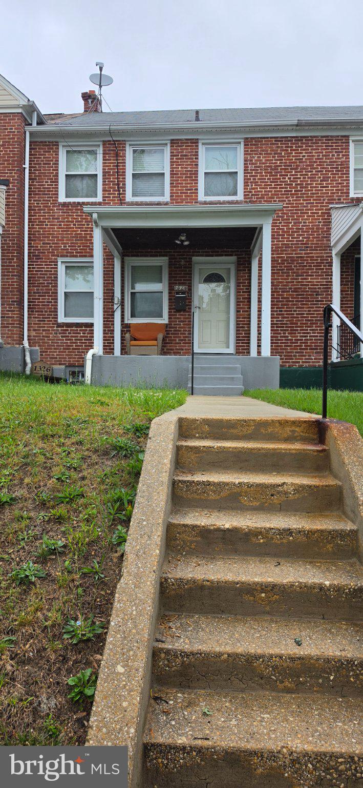1328 Cedarcroft Road Baltimore, MD 21239 - Photo 2 of 3 a front view of a house with a yard