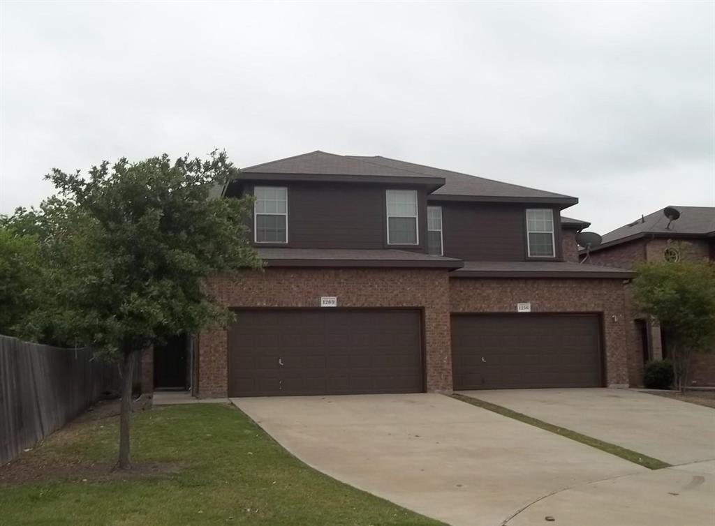 1256 Redman Avenue Mesquite, TX 75149 - Photo 1 of 8 a front view of a house with a yard and garage