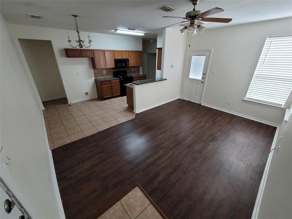 1256 Redman Avenue Mesquite, TX 75149 - Photo 2 of 8 a view of a kitchen with a sink a refrigerator wooden floor and a window