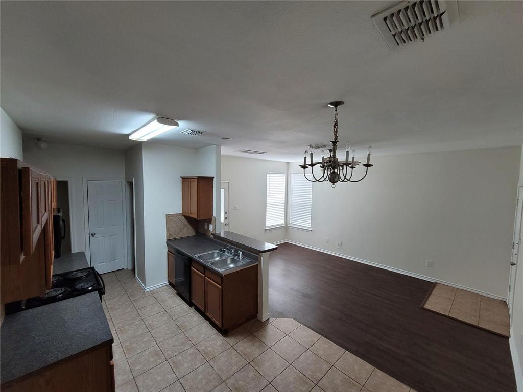 1256 Redman Avenue Mesquite, TX 75149 - Photo 3 of 8 a view of a room with gym equipment and wooden floor