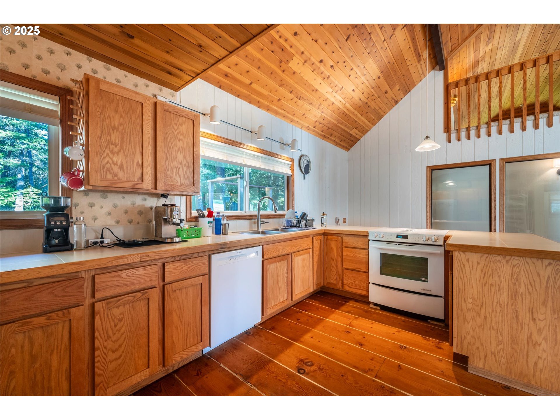 54177 Morrison Road Bandon, OR 97411 - Photo 15 of 47 a kitchen with stainless steel appliances kitchen island granite countertop a stove a sink and a microwave