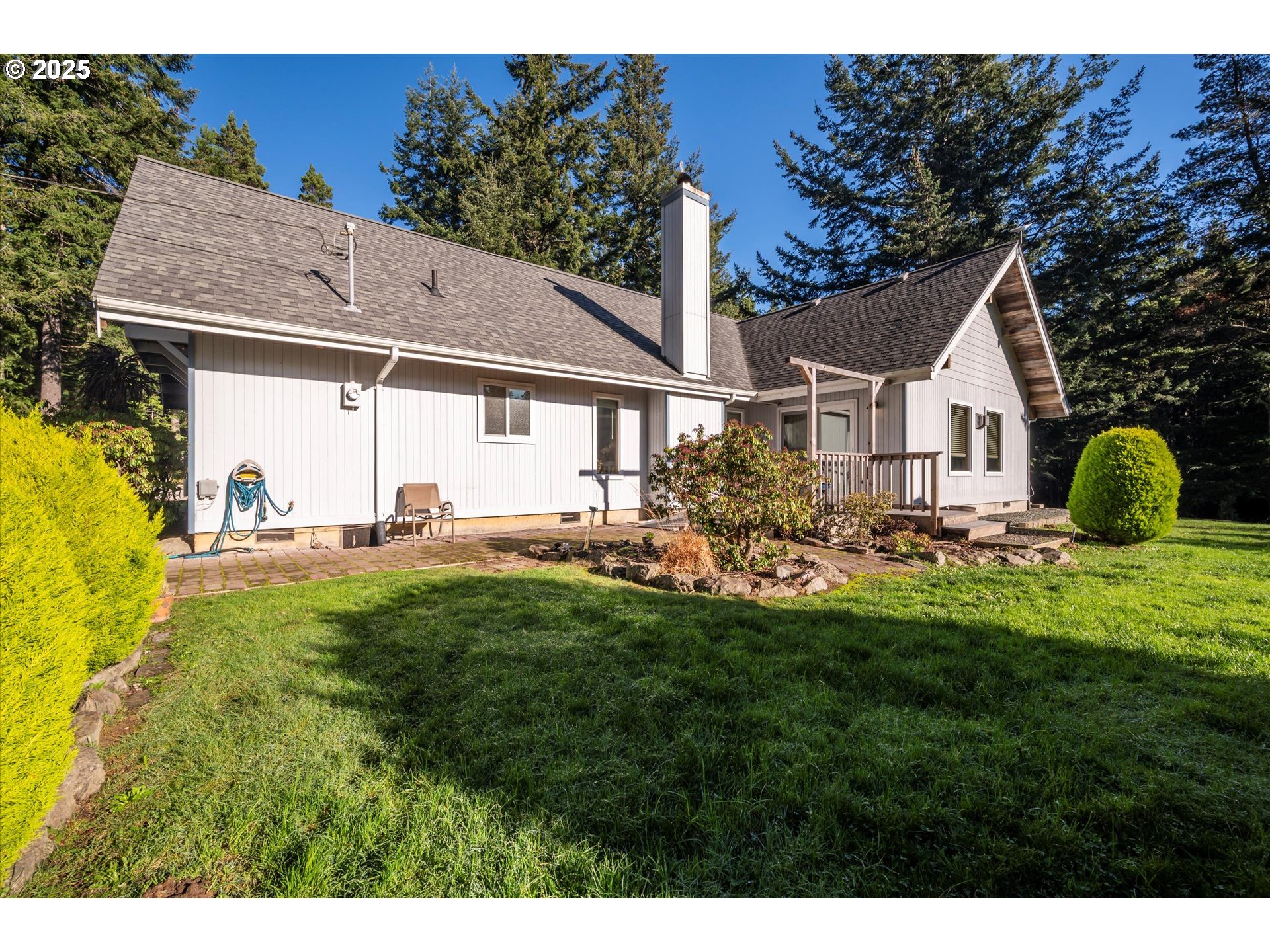 54177 Morrison Road Bandon, OR 97411 - Photo 2 of 47 a view of a house with a backyard porch and sitting area