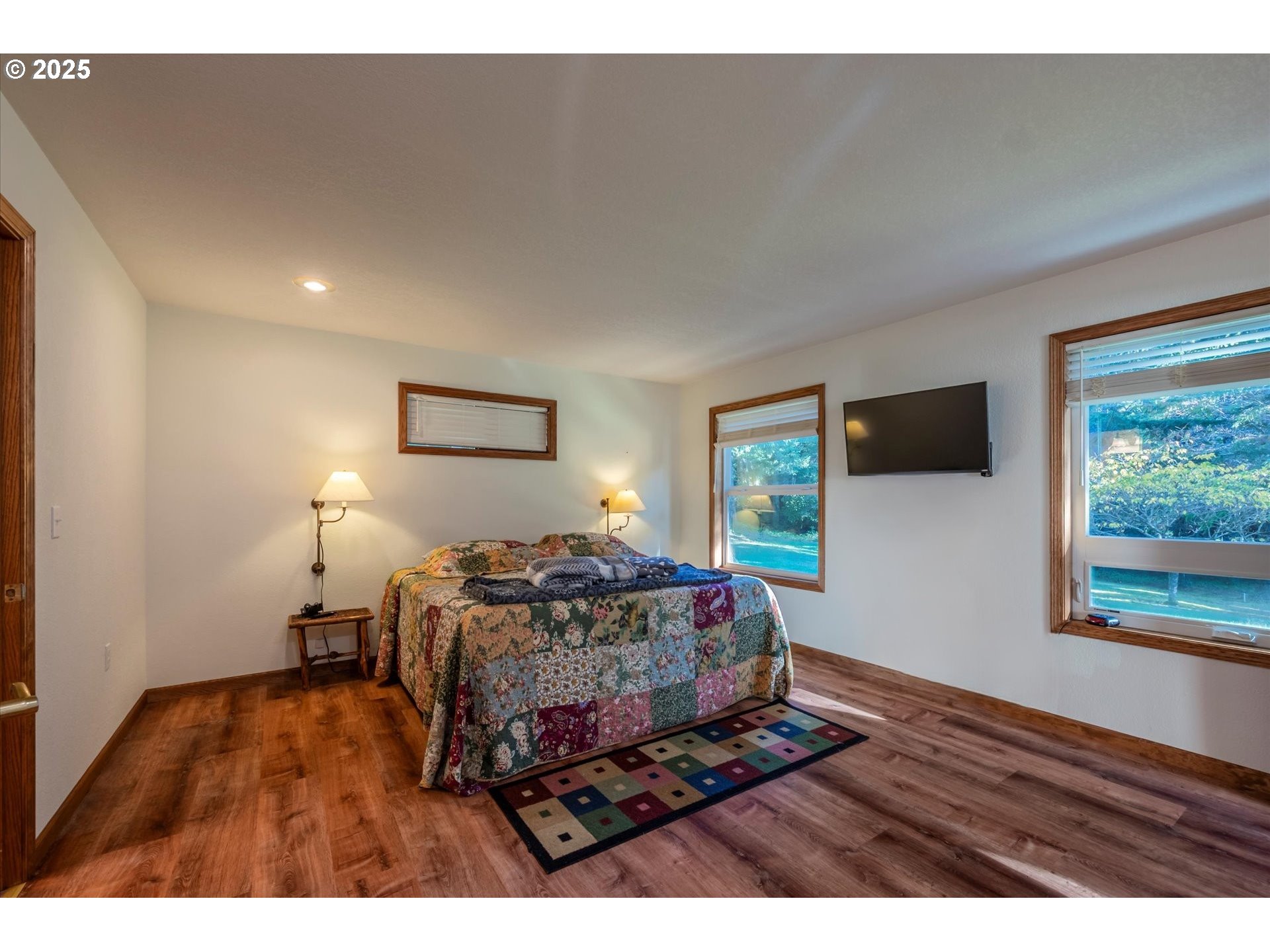 54177 Morrison Road Bandon, OR 97411 - Photo 24 of 47 a bedroom with a bed window and flat screen tv