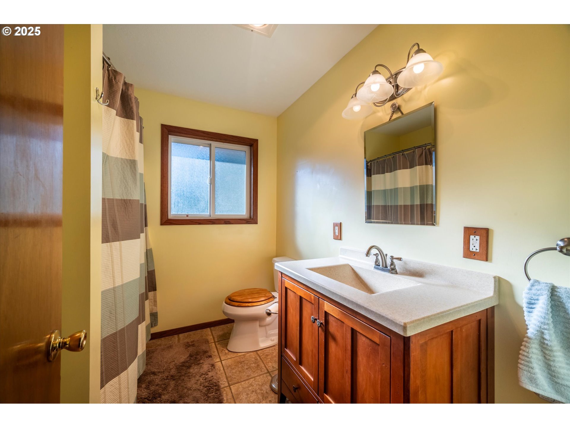 54177 Morrison Road Bandon, OR 97411 - Photo 28 of 47 a bathroom with a sink mirror and a toilet
