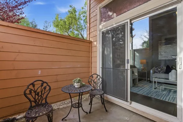 a view of a door and chair and table in the balcony