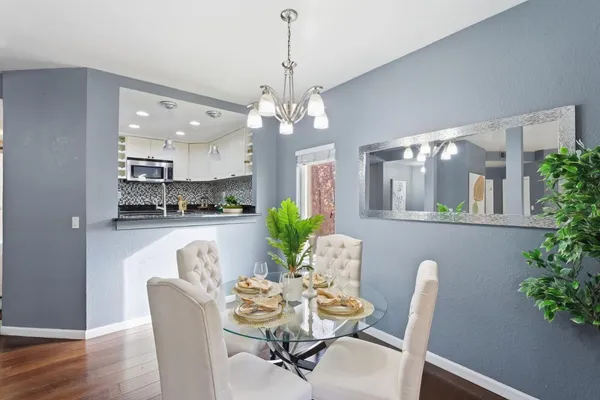 a dining room with furniture and potted plants