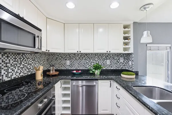 a kitchen with a sink a stove and cabinets