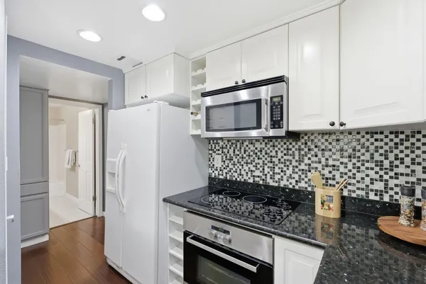 a kitchen with a stove and a refrigerator