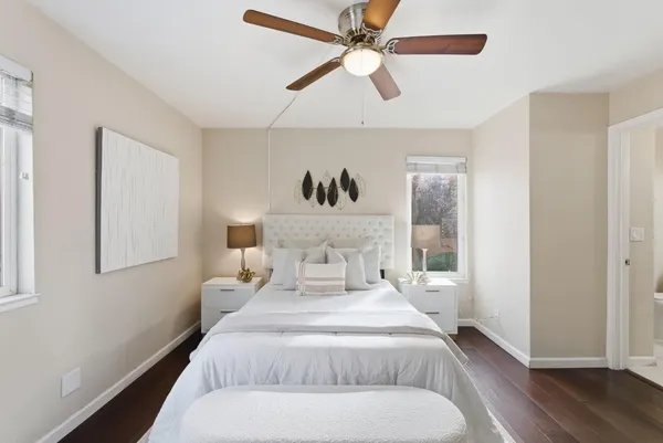 a bedroom with a large bed and a chandelier