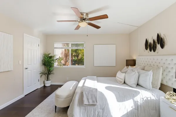 a bedroom with a bed and a potted plant