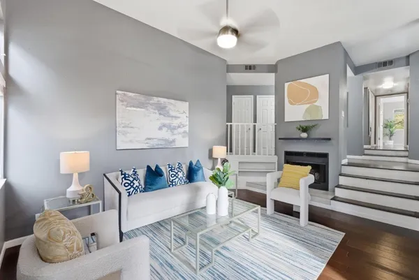 a living room with furniture and a painting on the wall