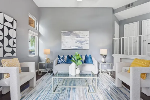 a living room with furniture and wooden floor