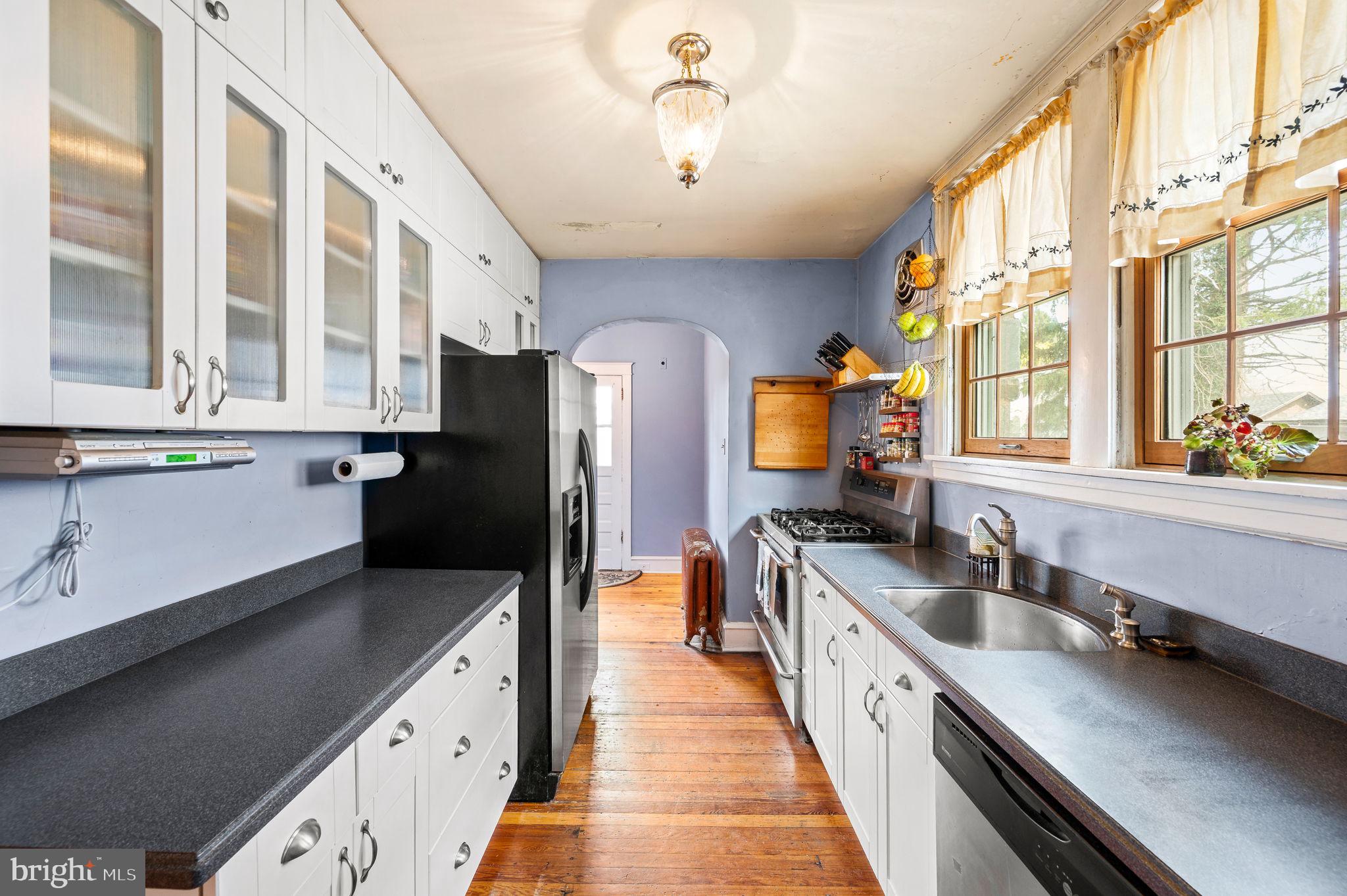 281 Wayne Avenue Lansdowne, PA 19050 - Photo 11 of 28 a kitchen with stainless steel appliances granite countertop a sink a stove and a refrigerator