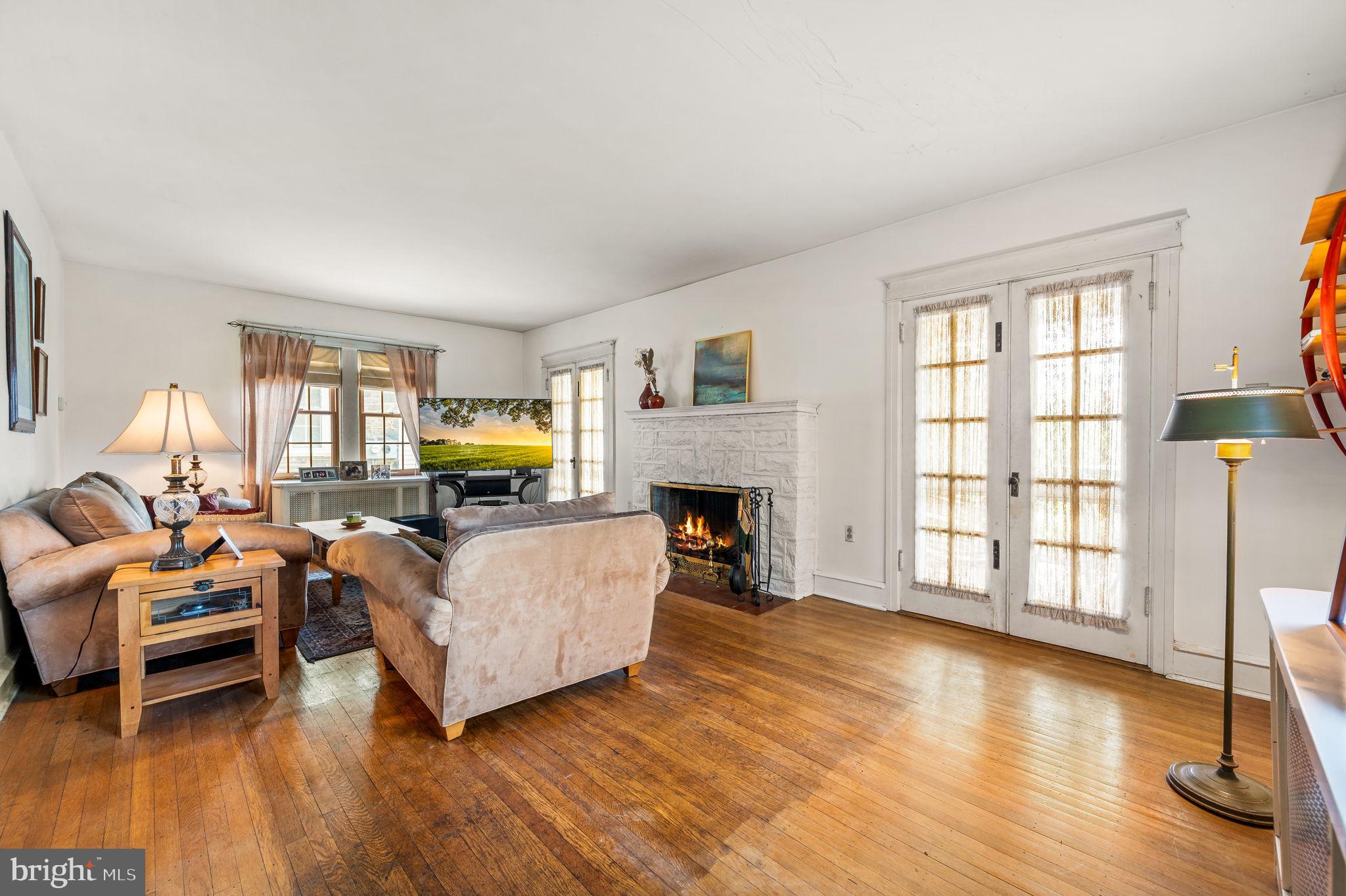 281 Wayne Avenue Lansdowne, PA 19050 - Photo 5 of 28 a living room with furniture and a fireplace