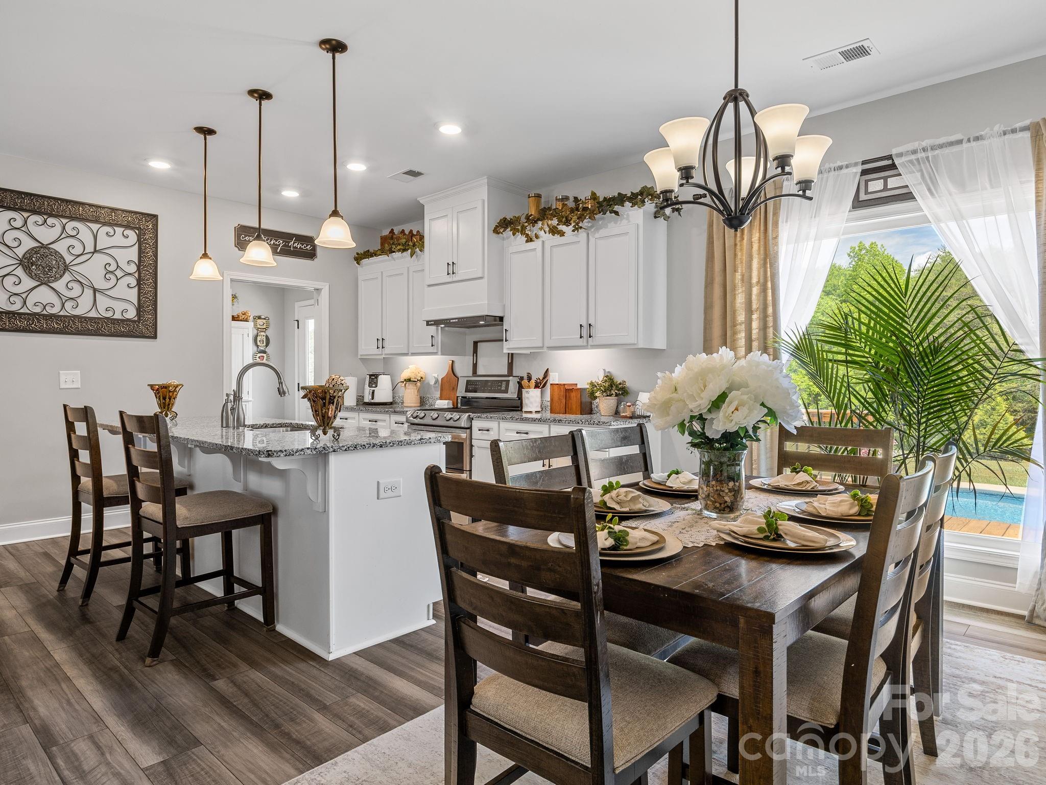 1076 McSwain Road Chesnee, SC 29323 - Photo 12 of 36 a dining room filled with furniture and a chandelier