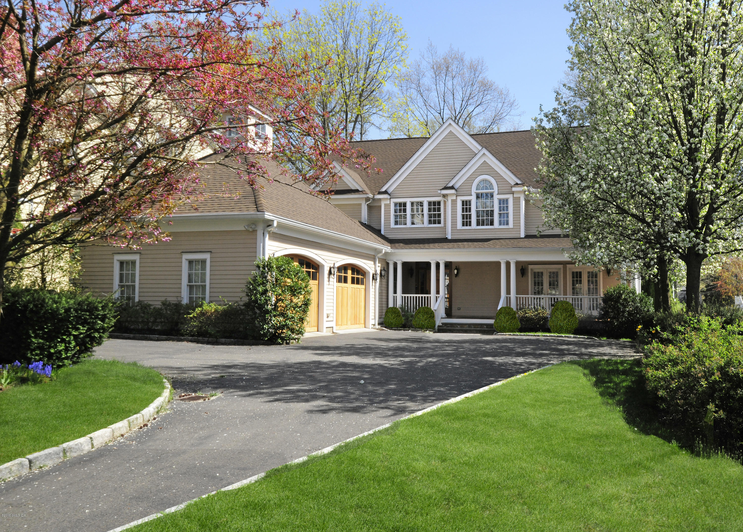 34 Hendrie Avenue Riverside, CT 06878 - Photo 28 of 28 a front view of a house with a yard and garage