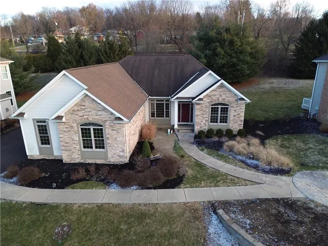 a aerial view of a house with a yard
