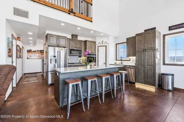 a living room with furniture a flat screen tv and a large window