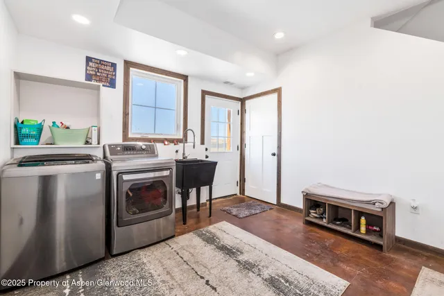 a kitchen with stainless steel appliances a stove a sink and a refrigerator