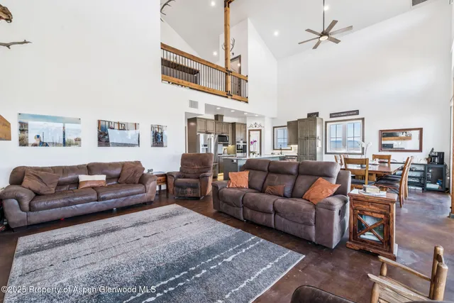 a view of a city from a dining room with furniture and window