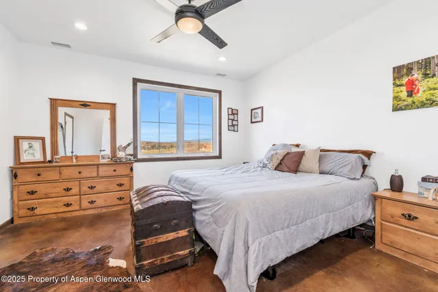 a bathroom with a granite countertop toilet sink and mirror