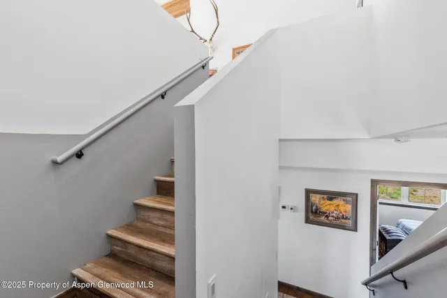 a bedroom with bed and wooden floor
