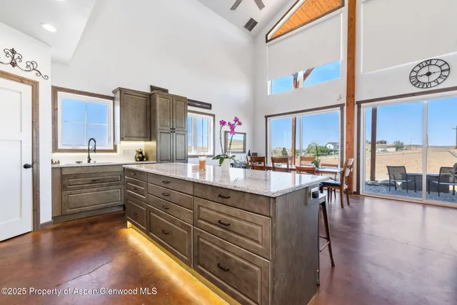 a kitchen with stainless steel appliances granite countertop a stove and a microwave