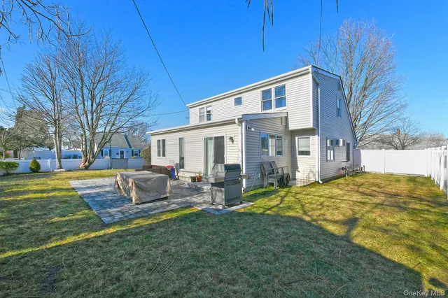 a view of a house with backyard and sitting area