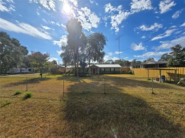 a view of a house with backyard porch and sitting area