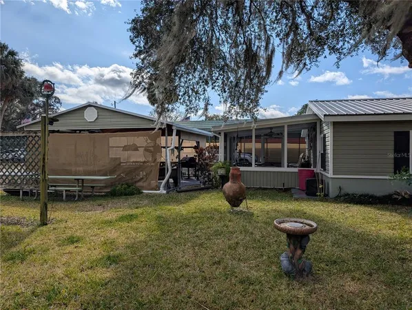 a view of a house with backyard and porch