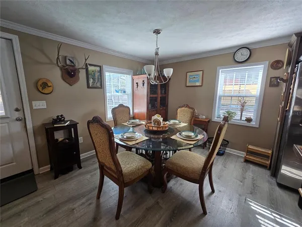a view of a dining room with furniture and window
