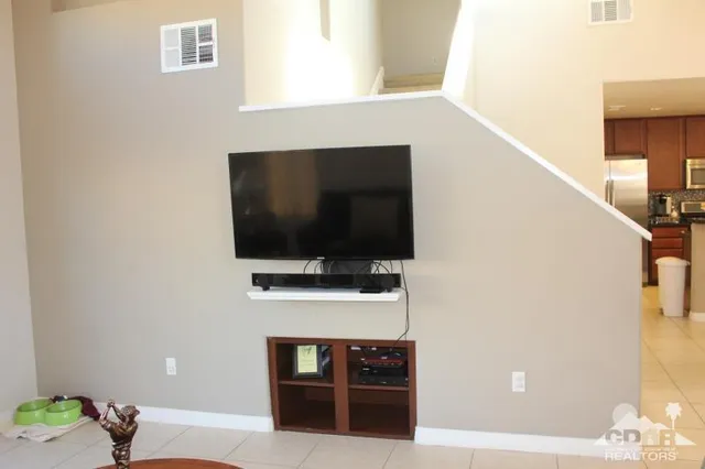 a bedroom with a bed a dresser and next to a window