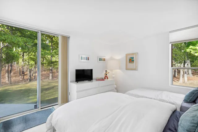 a bedroom with a bed and a book shelf