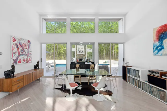 a living room with furniture and large windows