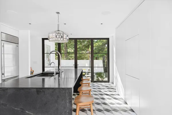 a very nice looking room with a large window and chandelier