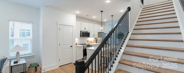 a kitchen with stainless steel appliances a stove a sink a microwave and cabinets
