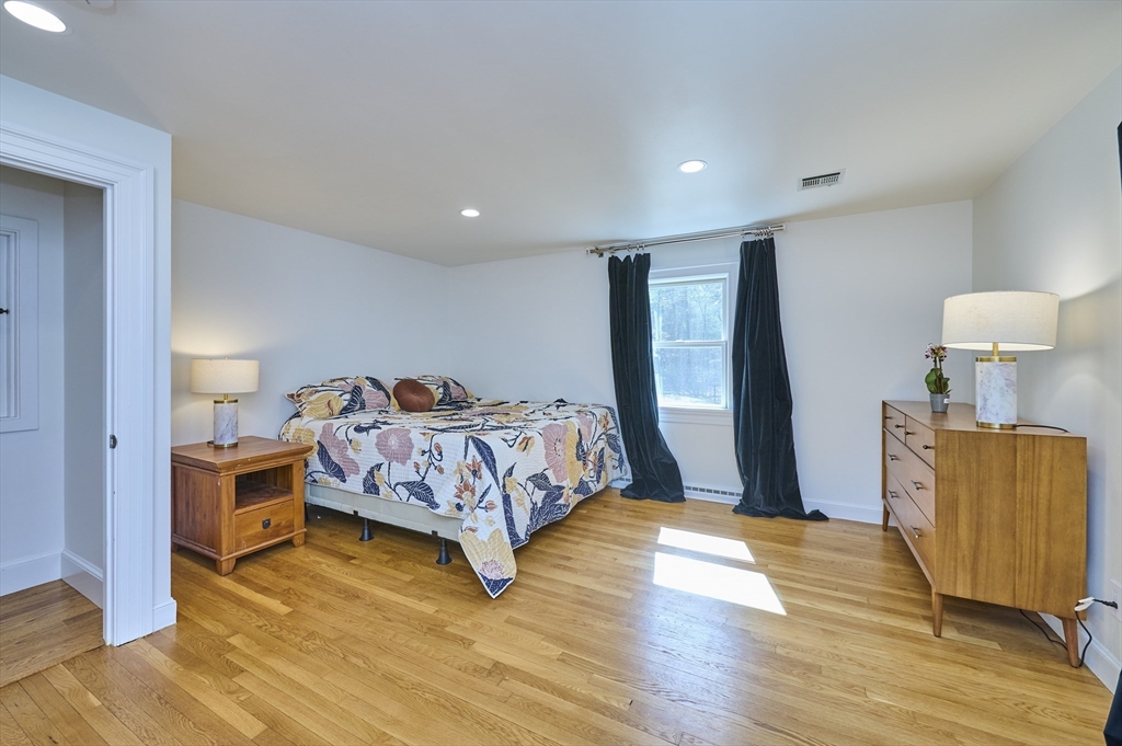42 Troutbrook Road Dover, MA 02030 - Photo 15 of 36 a bedroom with a bed and wooden floor