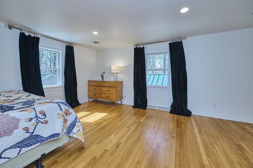 42 Troutbrook Road Dover, MA 02030 - Photo 16 of 36 a bedroom with a bed and wooden floor