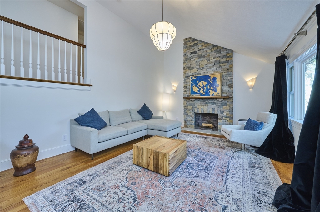 42 Troutbrook Road Dover, MA 02030 - Photo 4 of 36 a living room with furniture a fireplace and a table